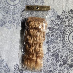 10 inch long human hair weft, curly golden blonde.